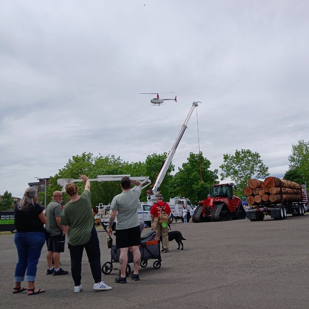 Crowd at SEDCOR event looking up at helicopter