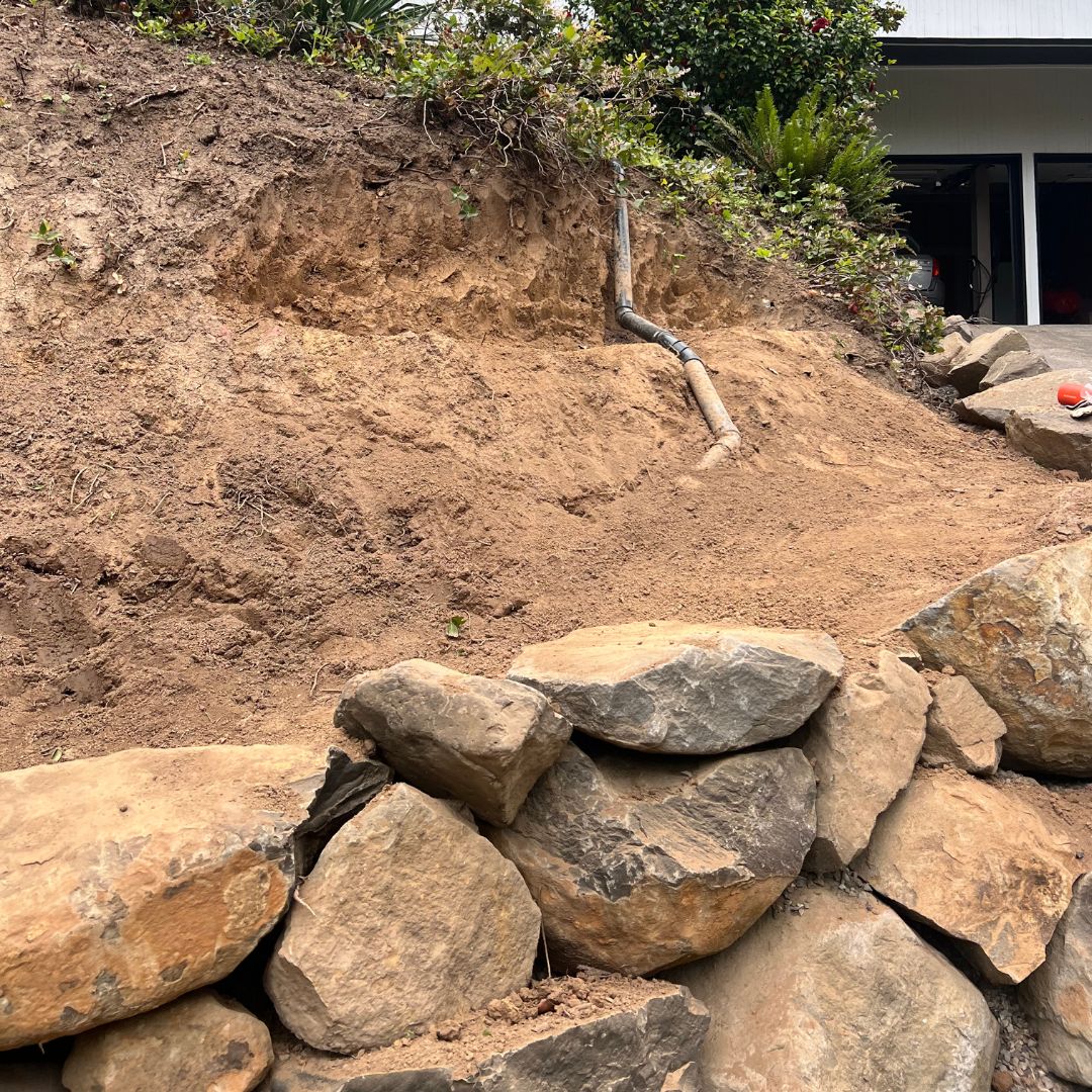 Close up of dirt wall with rock wall on bottom